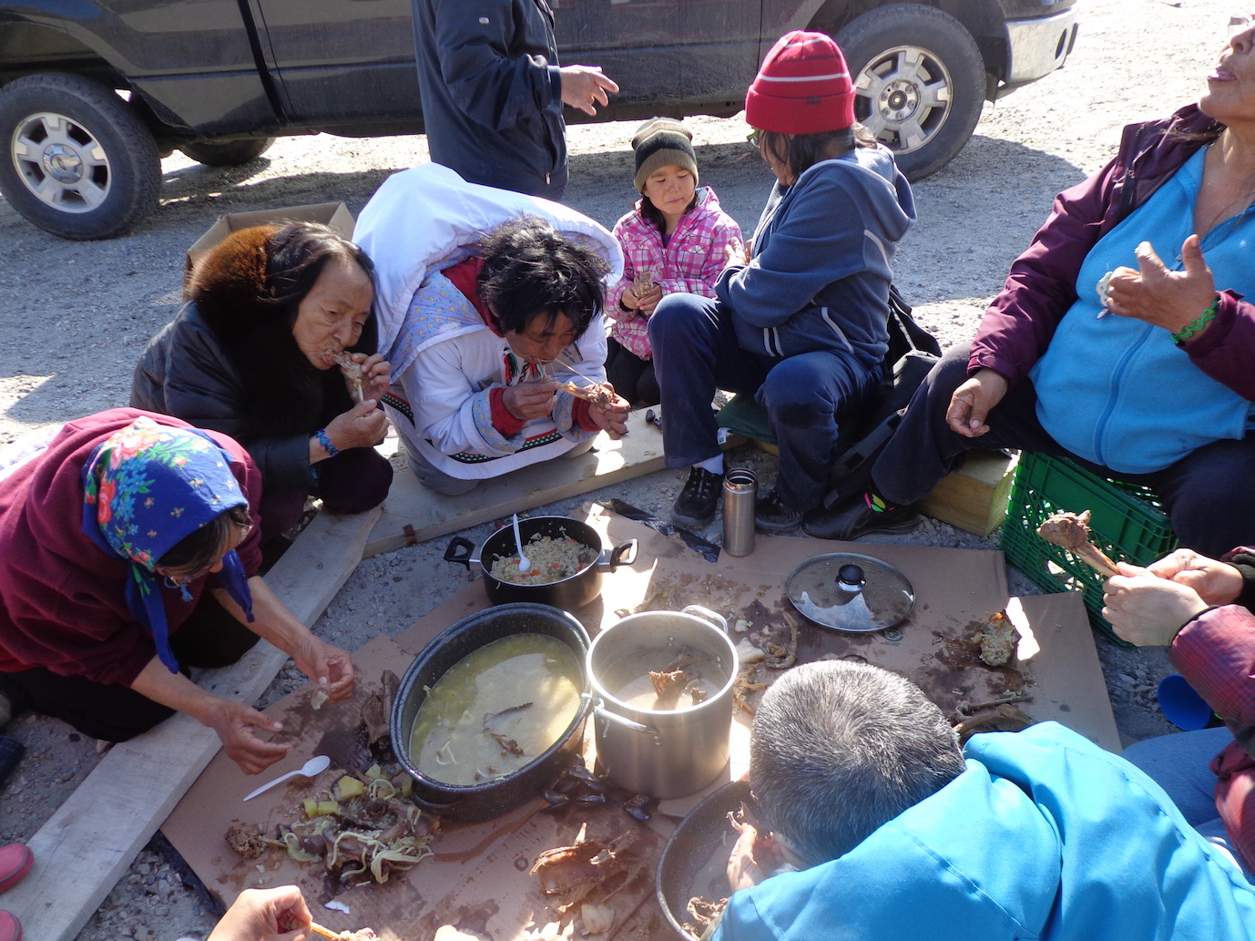 Photo 1: Kangiqsujuaq Elders enjoying a feast, June 16, 2014.